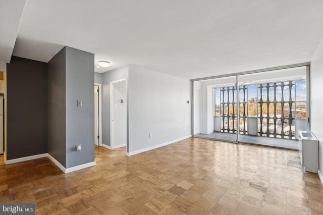 empty room featuring parquet flooring and a textured ceiling