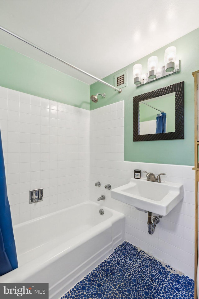 1301 Delaware Ave SW Unit N523, Washington, DC 20024 - full bathroom featuring tile walls, shower / tub combo, tile patterned flooring, and a sink
