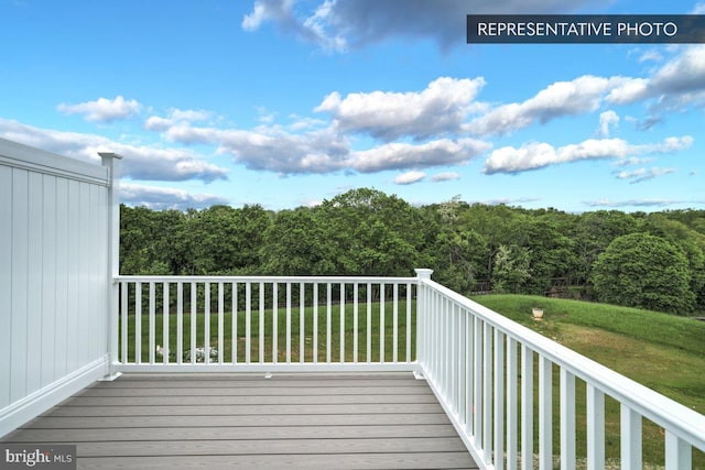 wooden terrace with a lawn