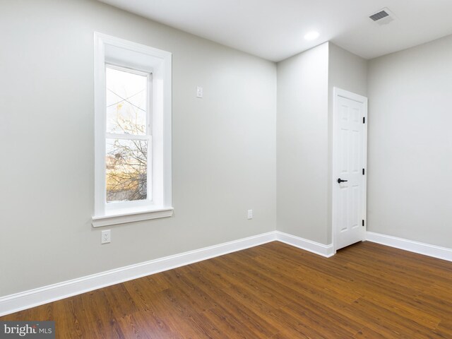 spare room featuring dark hardwood / wood-style flooring