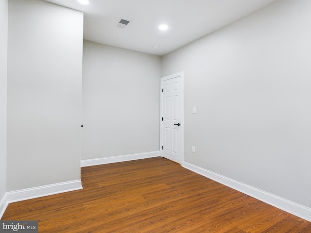 unfurnished room featuring dark hardwood / wood-style flooring