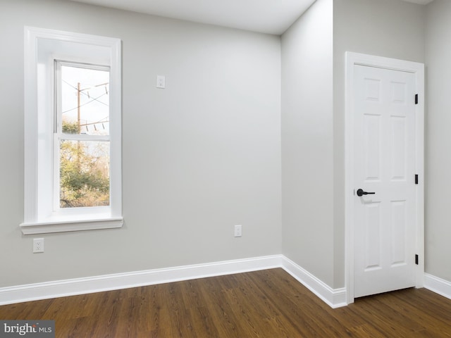 spare room with dark wood-type flooring