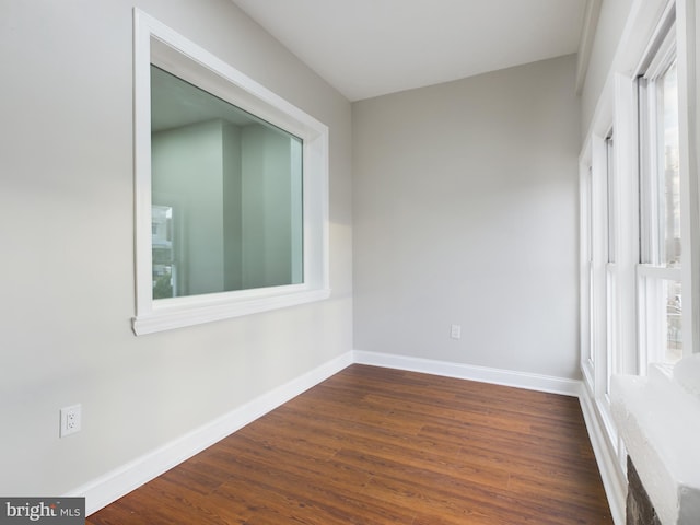 spare room with dark hardwood / wood-style floors