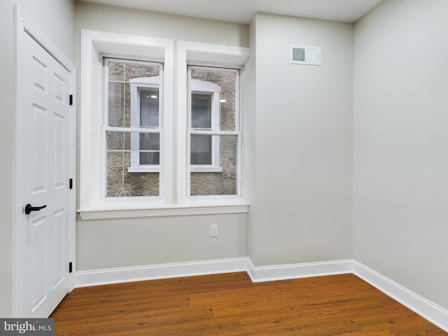 empty room with hardwood / wood-style floors