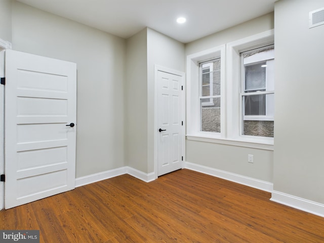 unfurnished room featuring hardwood / wood-style floors