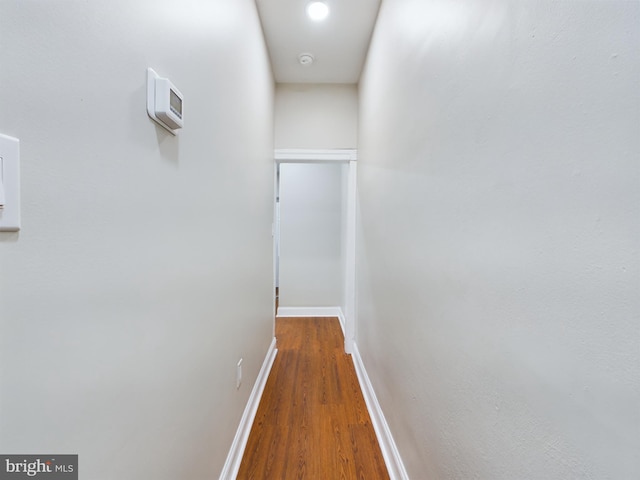 corridor with hardwood / wood-style floors