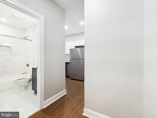 hallway with hardwood / wood-style floors