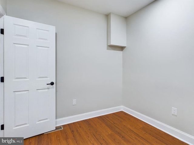 empty room with hardwood / wood-style floors