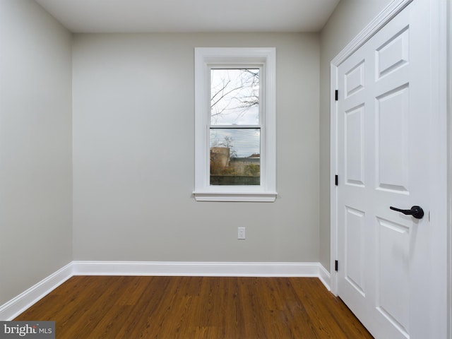 unfurnished room featuring dark hardwood / wood-style floors