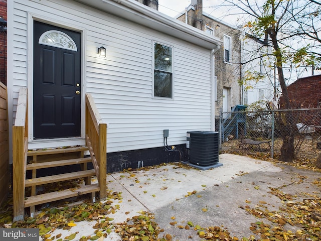 property entrance with a patio area and central air condition unit