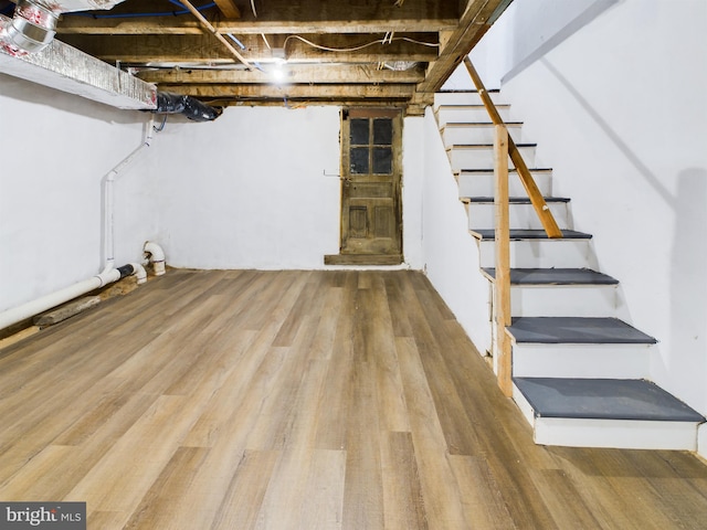 basement with hardwood / wood-style floors