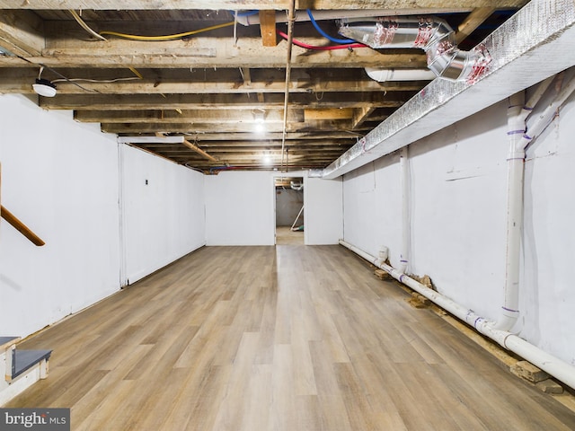 basement with light hardwood / wood-style floors