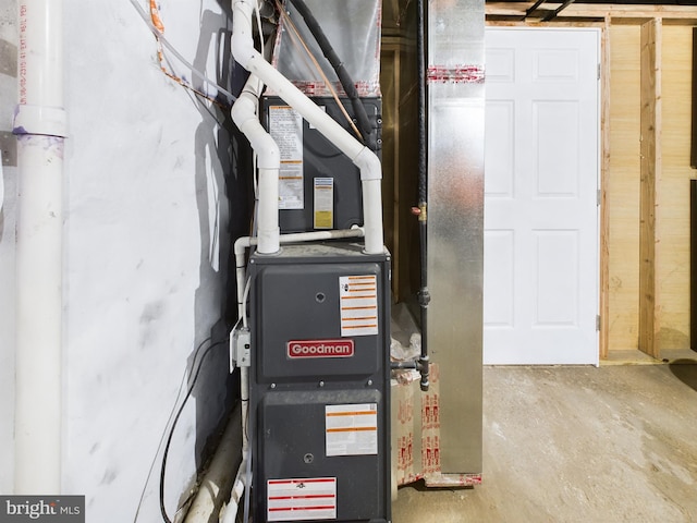 utility room featuring heating unit