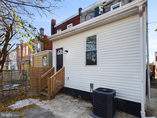 rear view of house with central AC unit