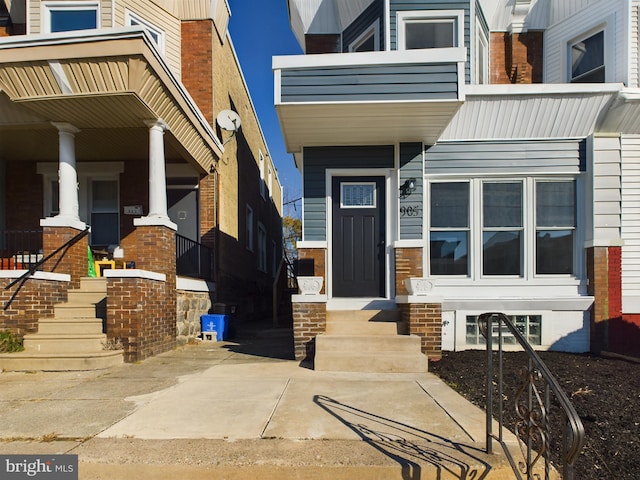 view of exterior entry with a porch