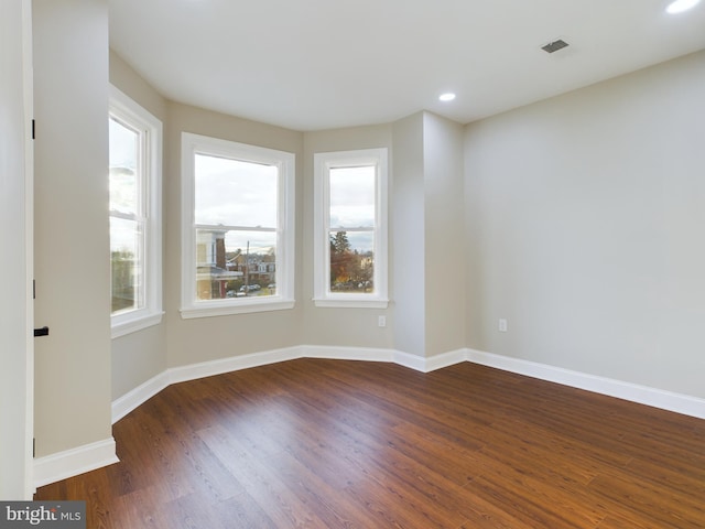 spare room with dark hardwood / wood-style floors