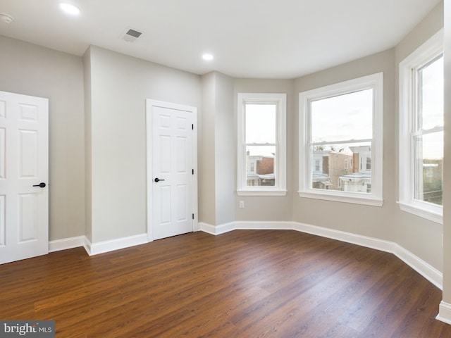 unfurnished room featuring dark hardwood / wood-style floors