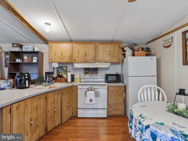 kitchen featuring sink, light wood-type flooring, vaulted ceiling, white appliances, and ornamental molding