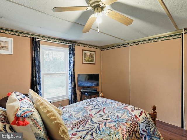 bedroom featuring hardwood / wood-style floors and ceiling fan