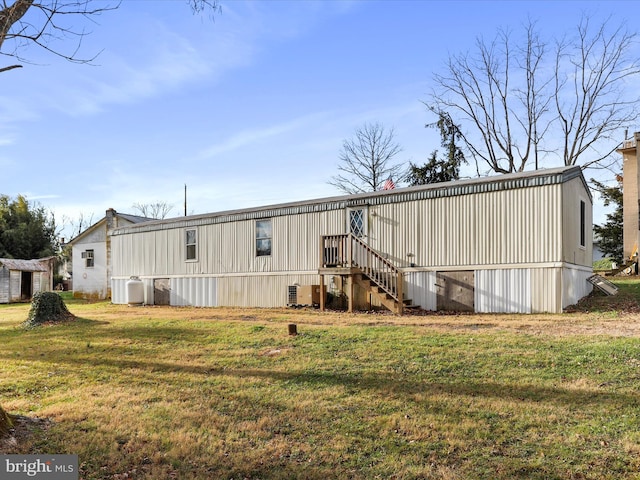 rear view of house with a yard