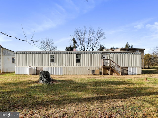 back of property featuring a yard and cooling unit