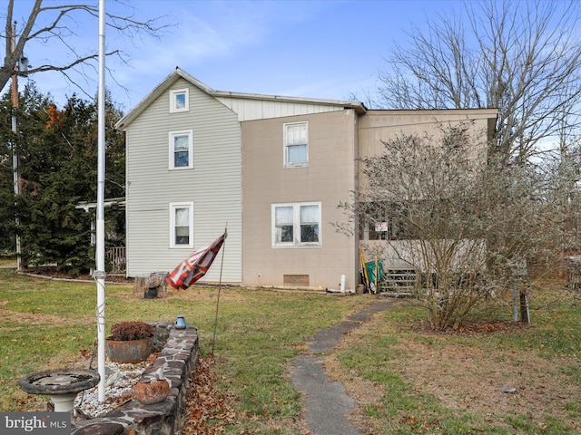 rear view of house with a yard