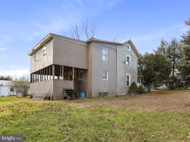 back of property with a lawn