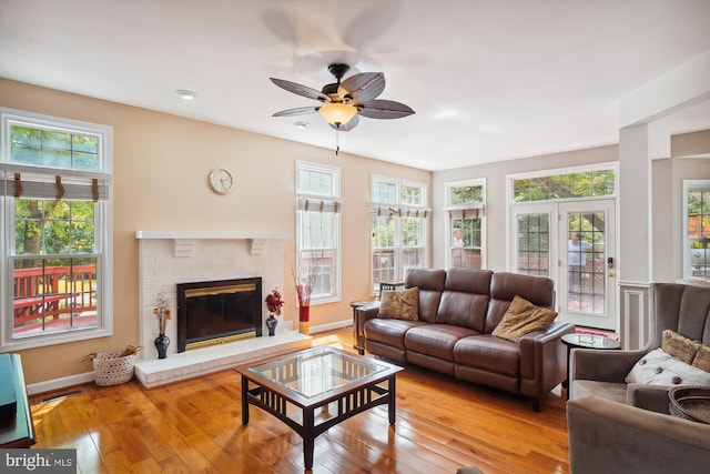 living area featuring hardwood / wood-style floors, a fireplace, and a wealth of natural light