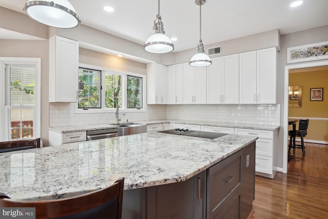 kitchen featuring dark wood-style floors, visible vents, white cabinetry, dishwasher, and black electric cooktop