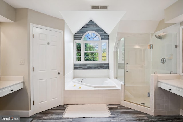 full bath with visible vents, a garden tub, a shower stall, and wood finished floors