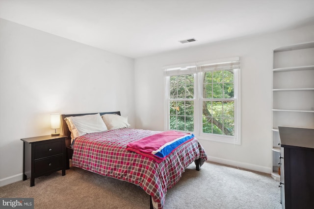 carpeted bedroom with visible vents and baseboards