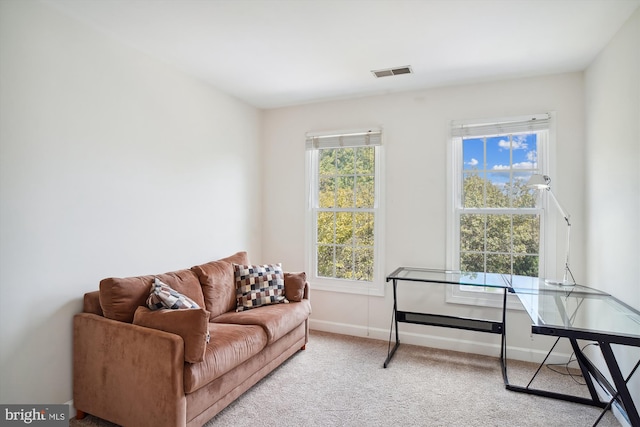 living room with carpet floors, plenty of natural light, visible vents, and baseboards