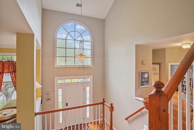 entrance foyer featuring stairs, visible vents, and wood finished floors