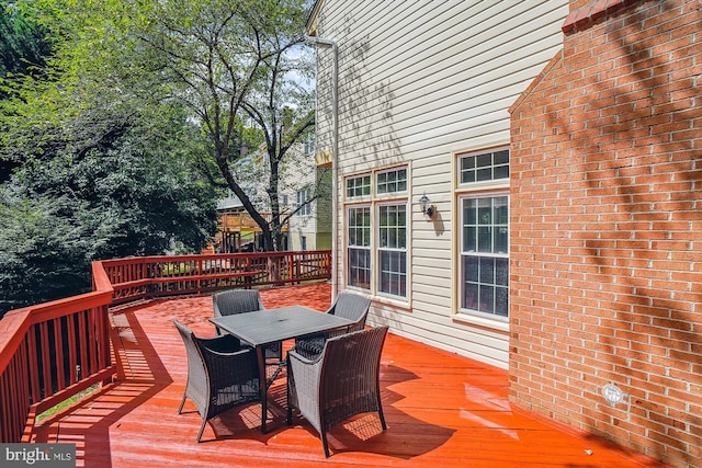 wooden deck featuring outdoor dining space