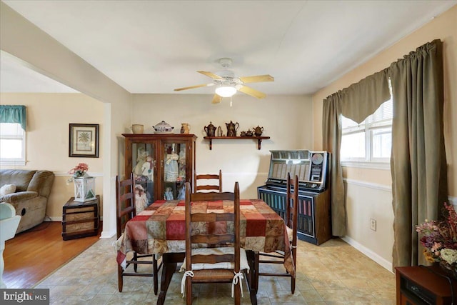 dining space featuring light wood-type flooring, plenty of natural light, and ceiling fan