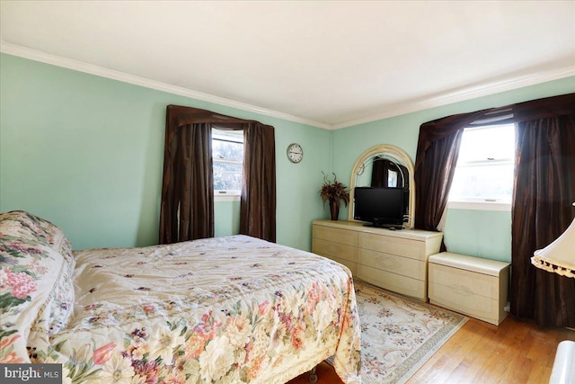 bedroom featuring light hardwood / wood-style floors and ornamental molding