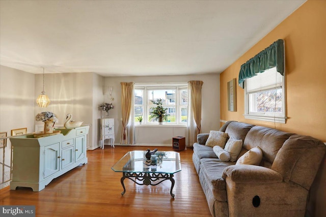 living room with a healthy amount of sunlight and light hardwood / wood-style floors