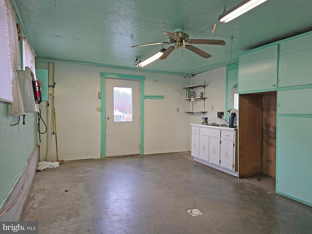 interior space with ceiling fan and sink