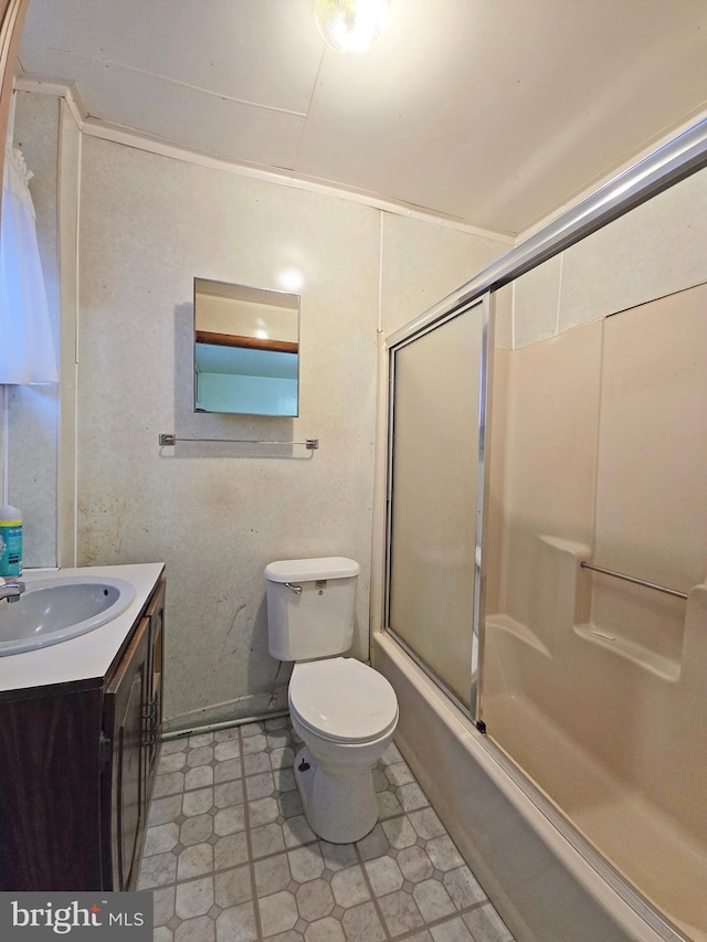 full bathroom with tile patterned floors, vanity, toilet, and combined bath / shower with glass door