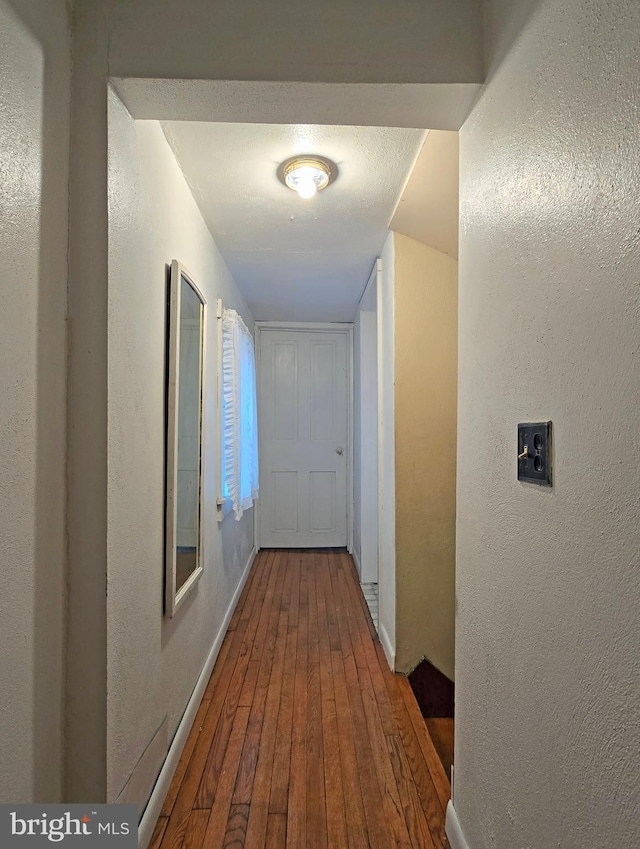 corridor with wood-type flooring