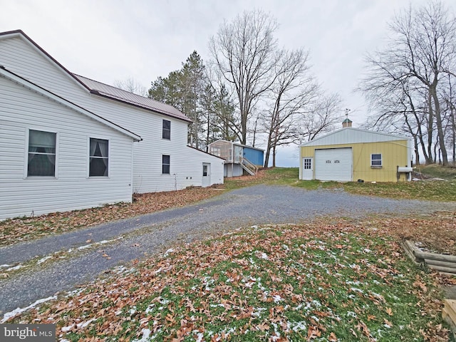 view of side of property featuring an outdoor structure and a garage