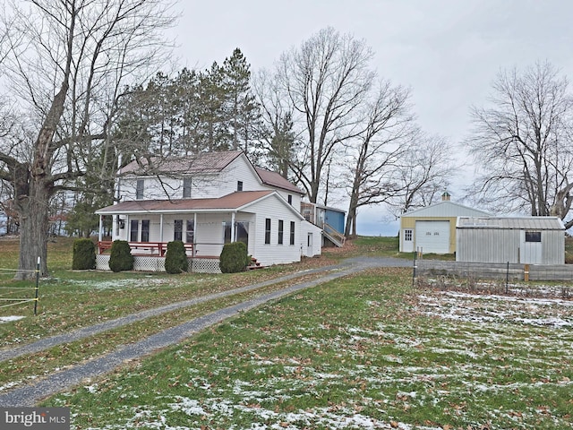 view of home's exterior featuring an outbuilding, a porch, a yard, and a garage