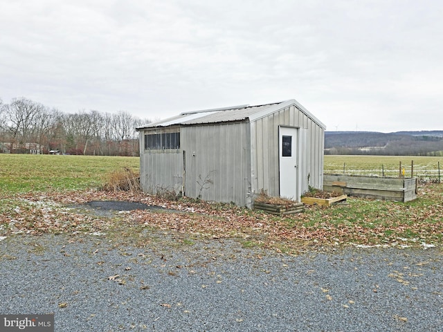 view of outdoor structure with a rural view