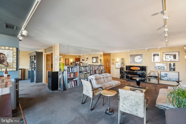 carpeted living room with track lighting