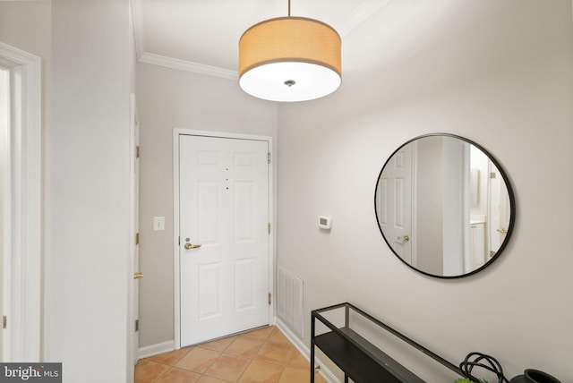 tiled foyer featuring crown molding