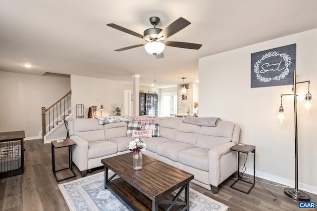 living room featuring wood-type flooring and ceiling fan