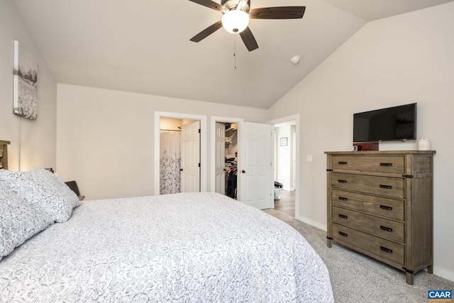 carpeted bedroom featuring a spacious closet, a closet, ceiling fan, and lofted ceiling