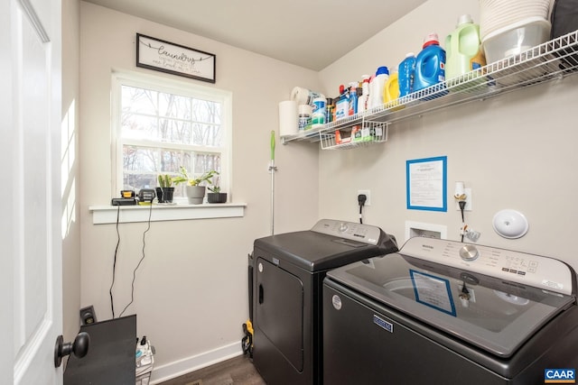 washroom featuring dark hardwood / wood-style flooring and washer and clothes dryer