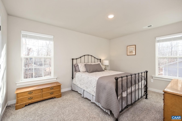 carpeted bedroom with multiple windows