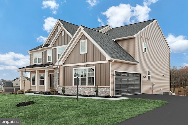 view of front of property featuring a front yard and a garage